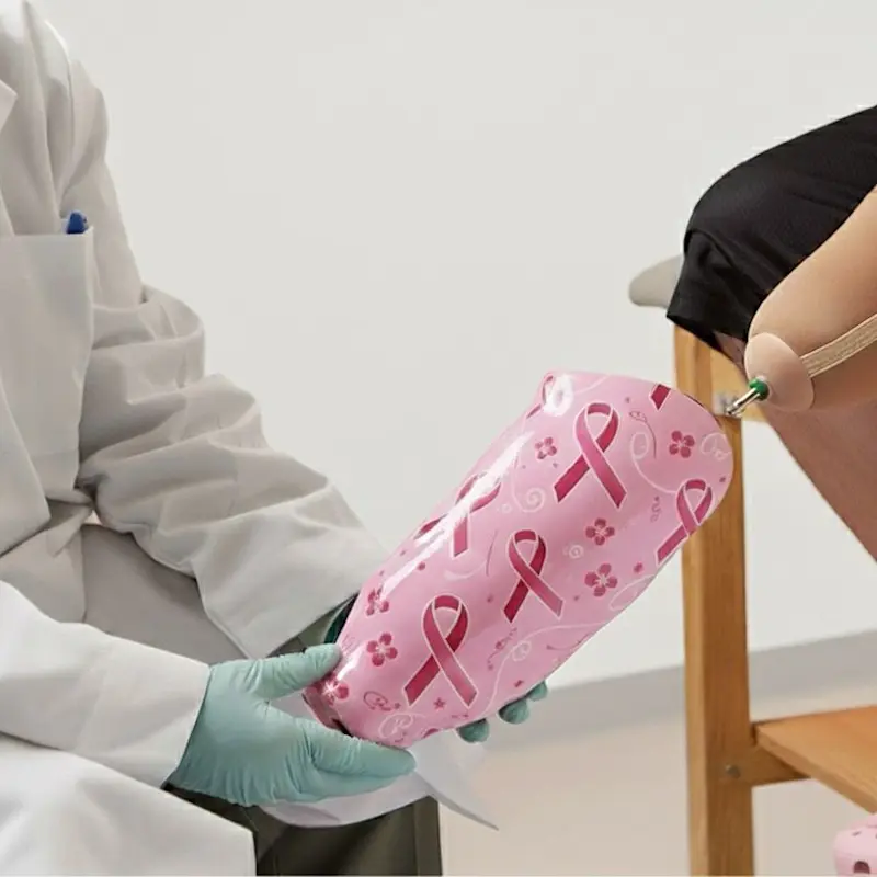 A custom prosthetic leg with a Breast Cancer Awareness ribbon design