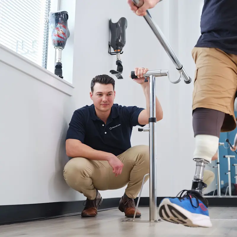 A Certified Prosthetist Orthotist observing an prosthetic user's gait in a clinic setting