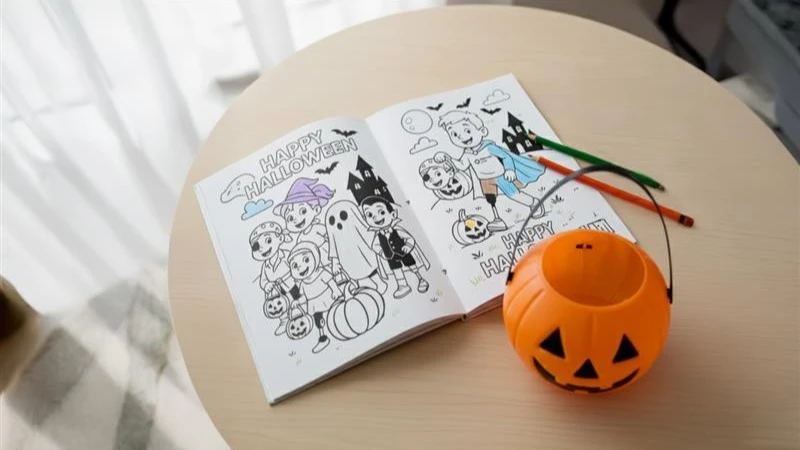 The Ottobock Care Halloween Coloring Book on a kitchen tabletop, partially completed