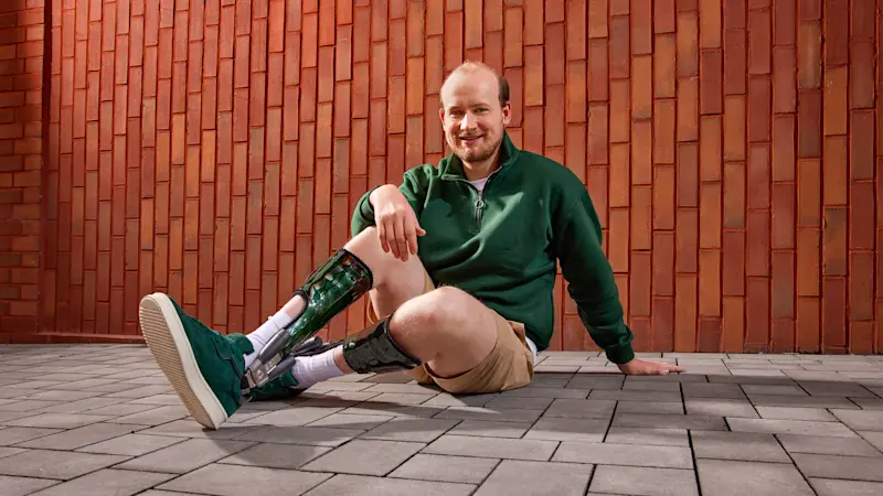 A person with limb difference posing in their Hinged Ankle Foot Orthotic 