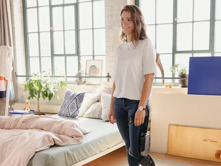 A C-Brace user standing in their bedroom