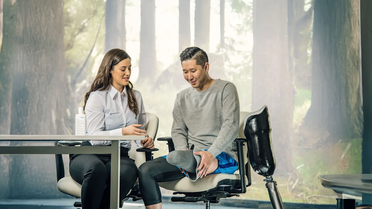 An above-knee amputee consulting with their prosthetist about their residual limb