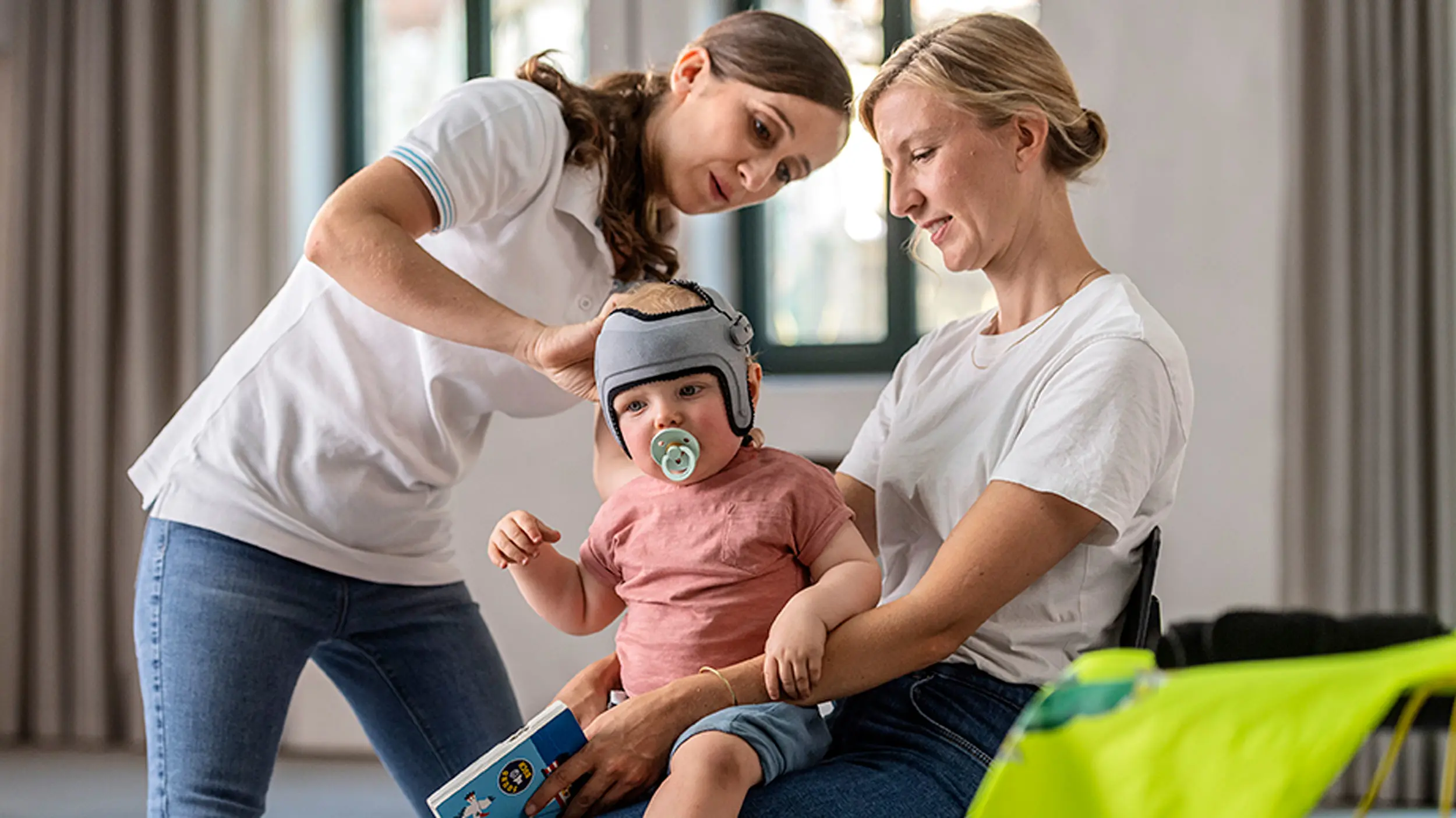 A Certified Orthotist putting the MyCRO Band helmet on an infant's head