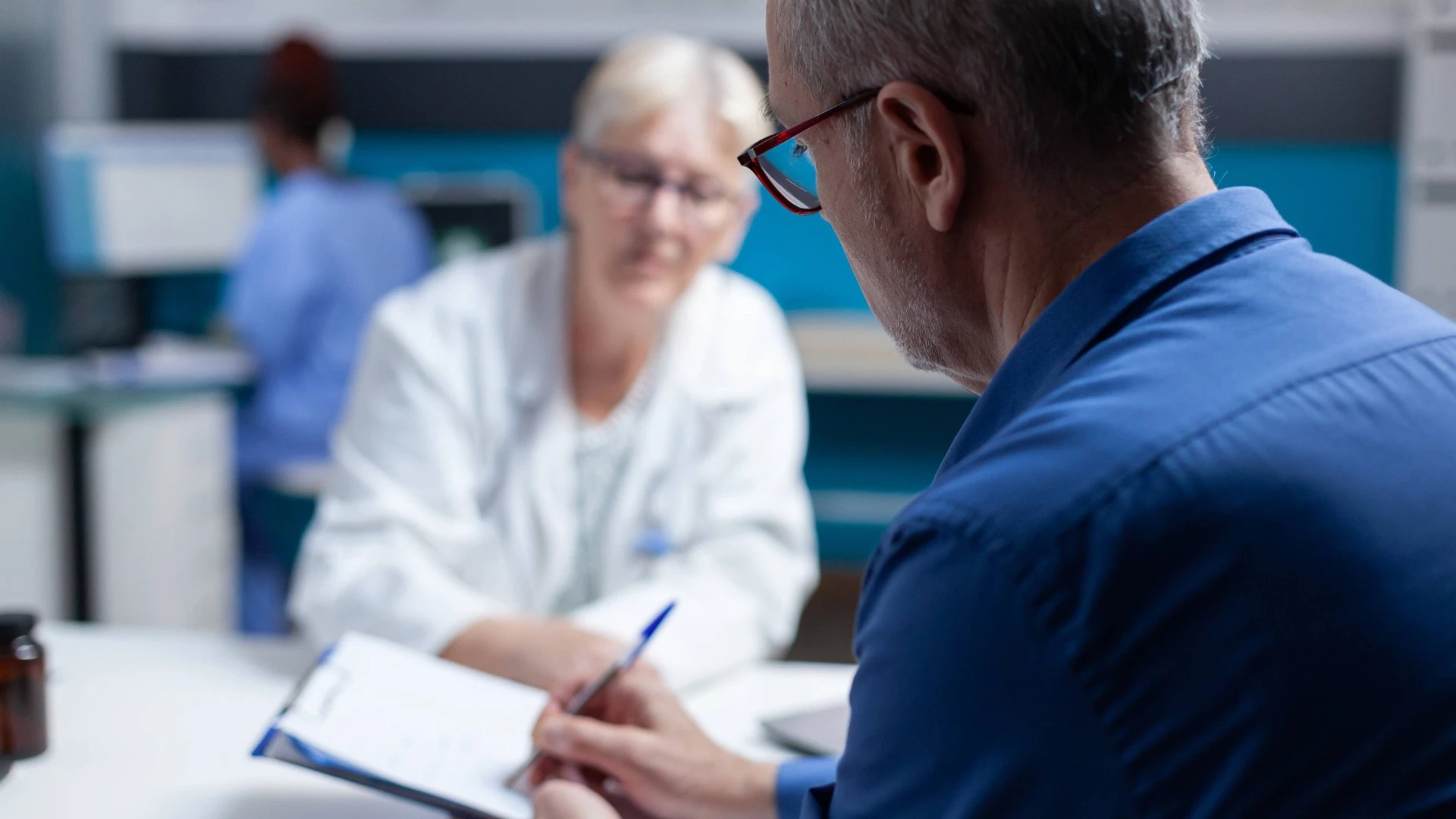 An elderly patient filling out medical documents