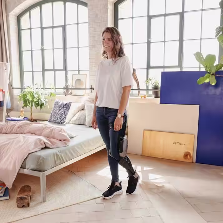 Woman walking in bedroom with C-Brace