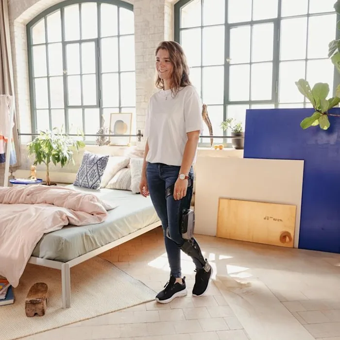 Woman walking in bedroom with C-Brace