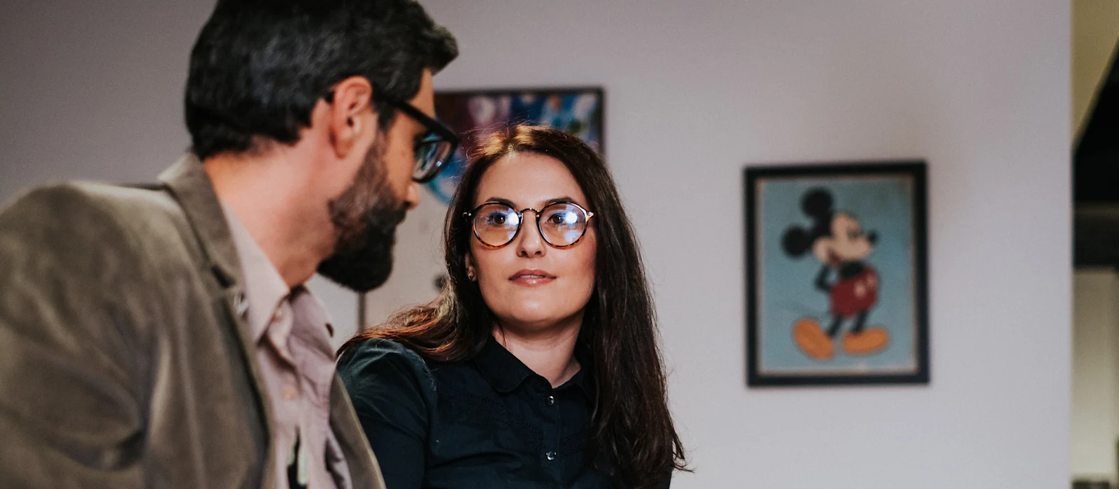 Two co-workers discussing a project in a meeting
