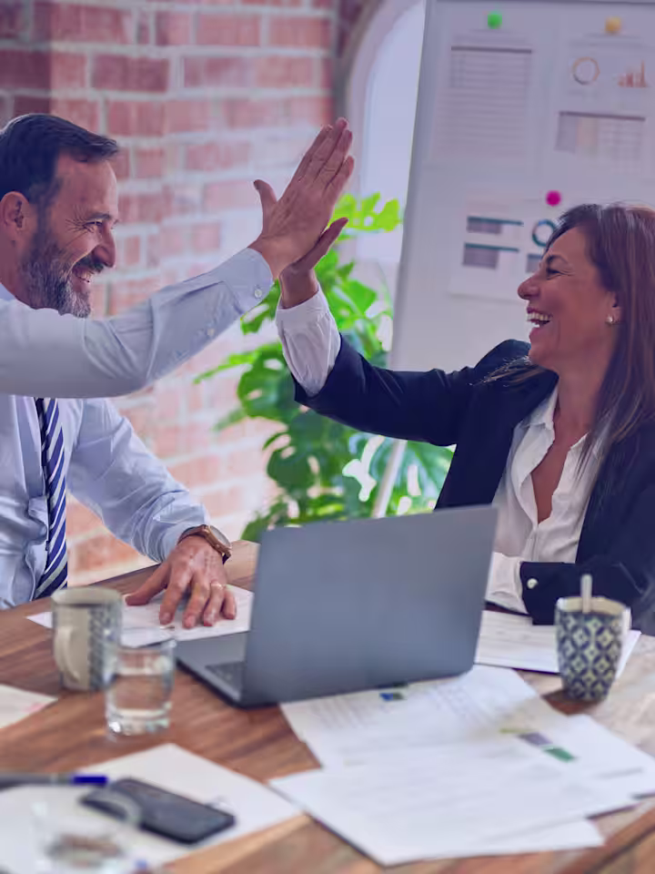 Two colleagues celebrating a professional accomplishment
