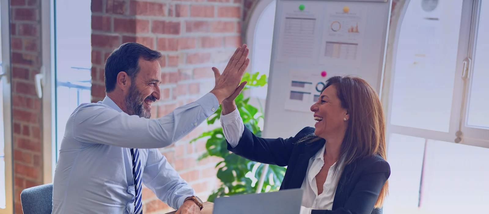 Two colleagues celebrating a professional accomplishment