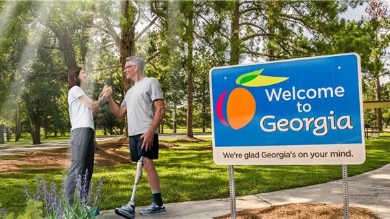 A Prosthetist cheering a kenevo microrpocessor knee user on a walking trail