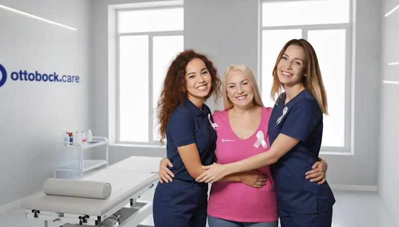 A group of women hugging each other in an Ottobock Care clinic