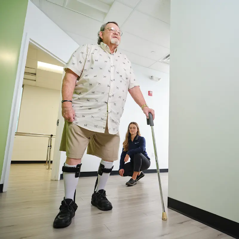 A lower leg orthosis user trialing a product with the supervision of a Certified Prosthetist Orthotist