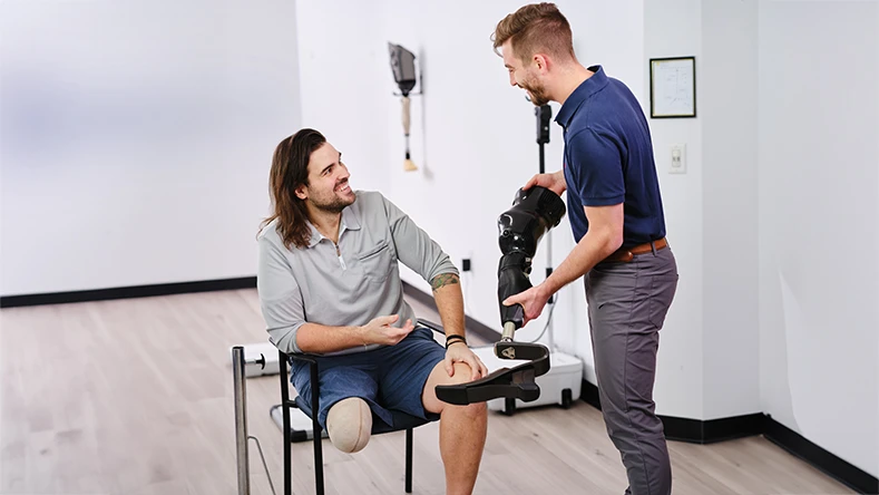 A Certified Prosthetist Orthotist consulting on prosthetic legs with a patient