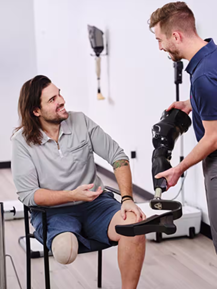 A Certified Prosthetist Orthotist consulting on prosthetic legs with a patient