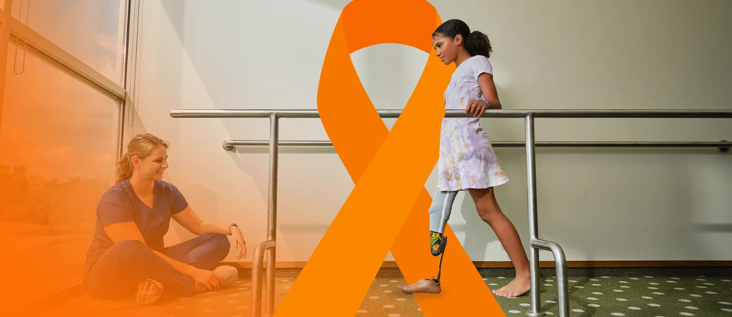 A certified prosthetist orthotist (CPO) assessing a child's prosthetic device by observing their gait