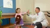 A pediatric patient high fiving their orthotist