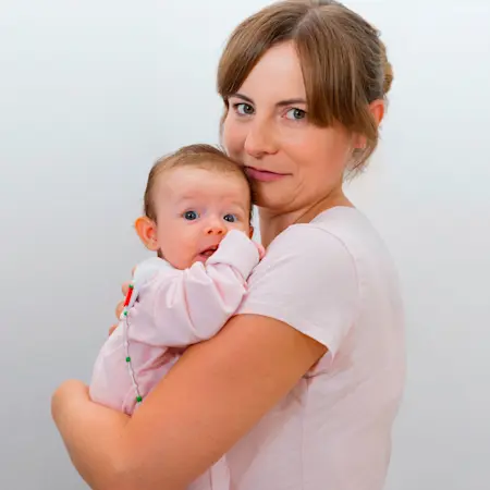 Una mamma abbraccia il suo bambino con addosso l'ortesi pediatrica Tubingen