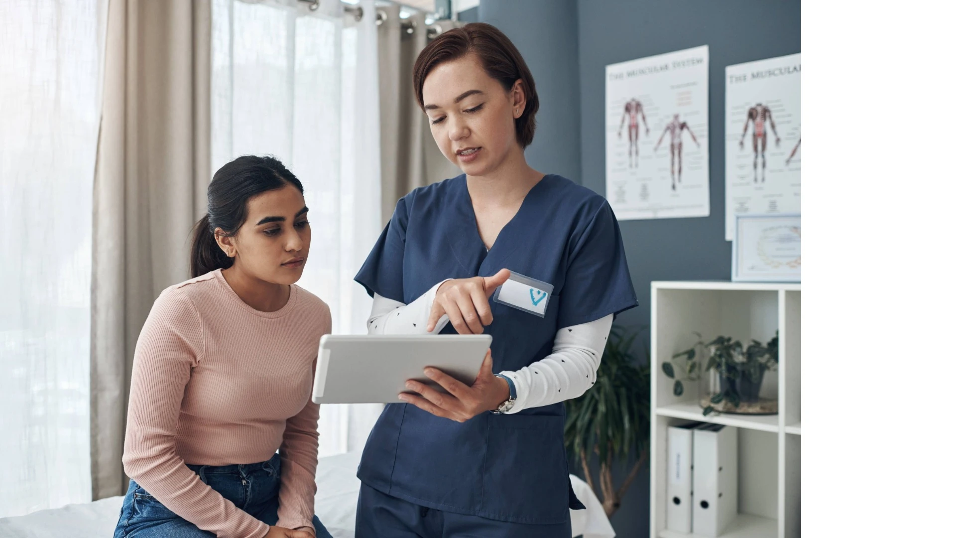 A Patient Navigator discussing expectations for post-amputation recovery with a patient in a hospital setting