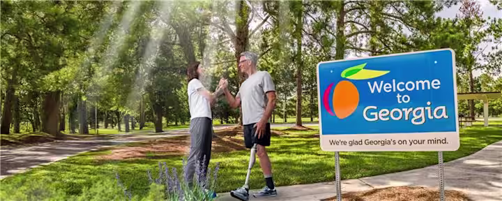 A prosthetic leg user greeting a Prosthetist on an outdoor trail