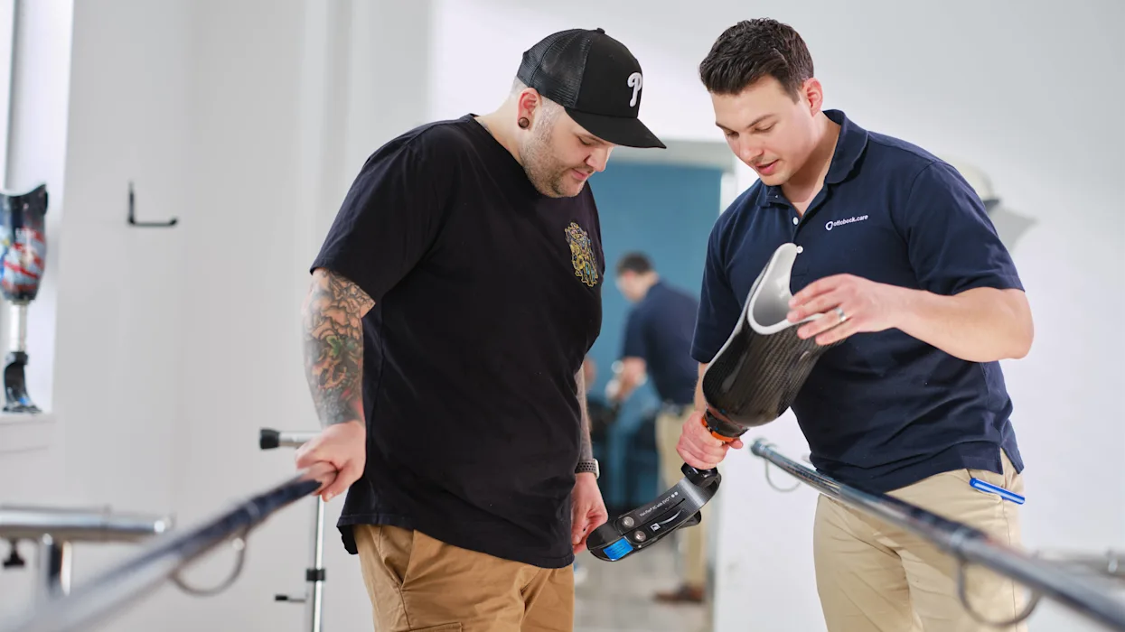 A Certified Prosthetist Orthotist consulting with lower limb prosthetic leg user on how to maintain their prosthesis