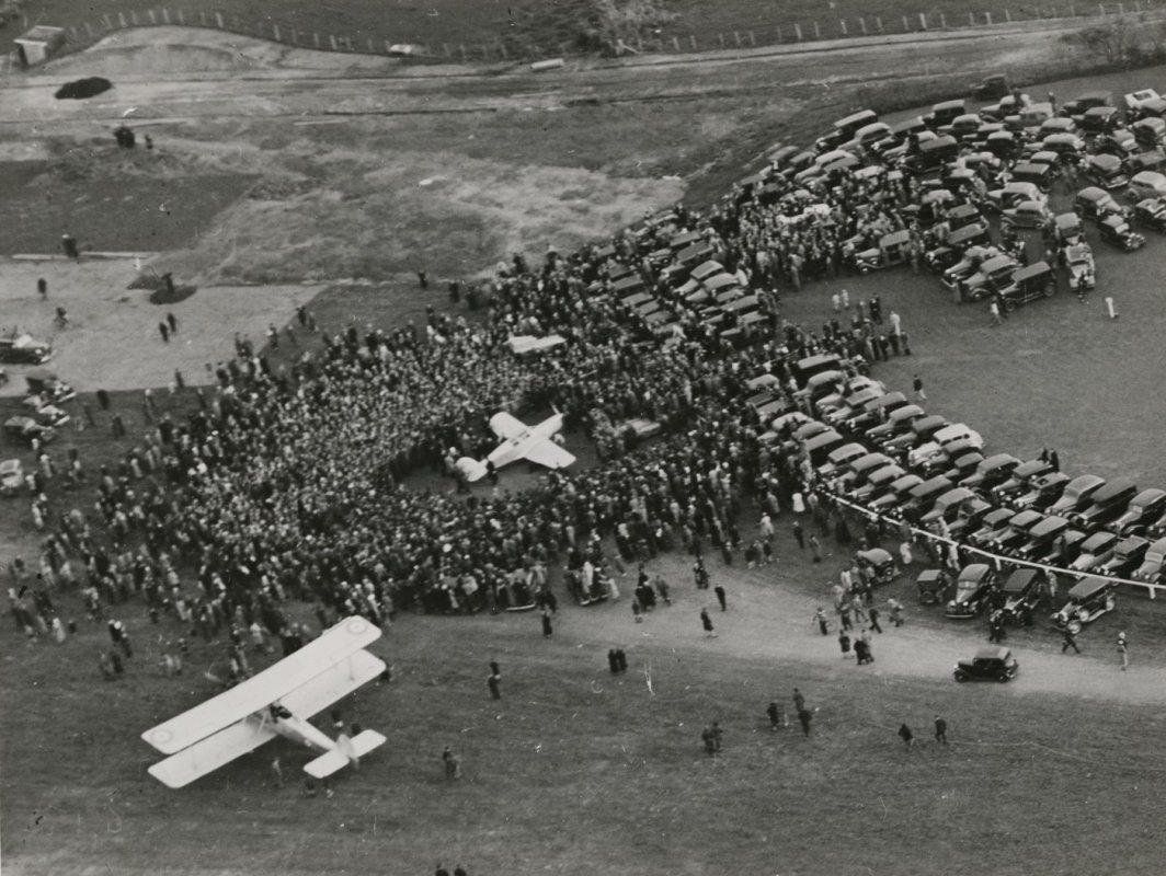 Jean Batten arrives to a large crowd at Mangere, Auckland after her solo flight from England to New Zealand in 1936.