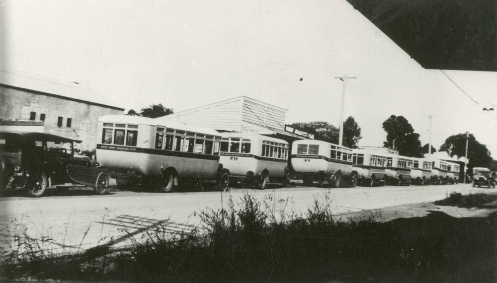 North Shore Transport Company buses lined up at Milford. No. 4 is the third bus from the left. Auckland Libraries Heritage Collections T0489, No known copyright restrictions. Unknown photographer.  Circa 1930-1930. 