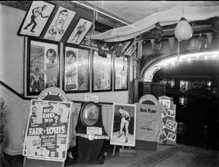Movie posters in theatre lobby, 1930s. John McGuire et al. 13-2052. Walsh Memorial Library, The Museum of Transport and Technology (MOTAT).