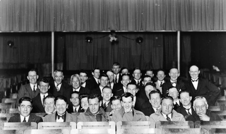 Group portrait of men seated in theatre, 1930s. Unidentified et al. 13-2183. Walsh Memorial Library, The Museum of Transport and Technology (MOTAT).