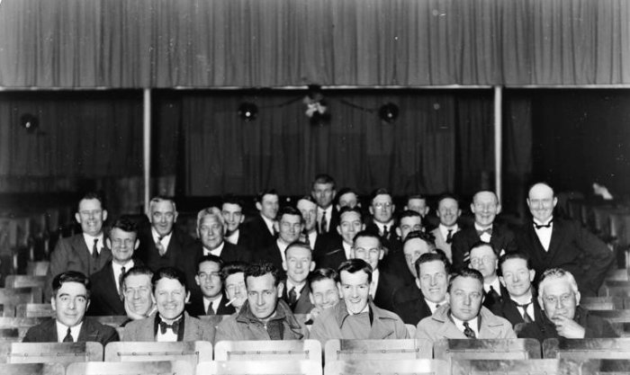 Group portrait of men seated in theatre, 1930s. Unidentified et al. 13-2183. Walsh Memorial Library, The Museum of Transport and Technology (MOTAT).