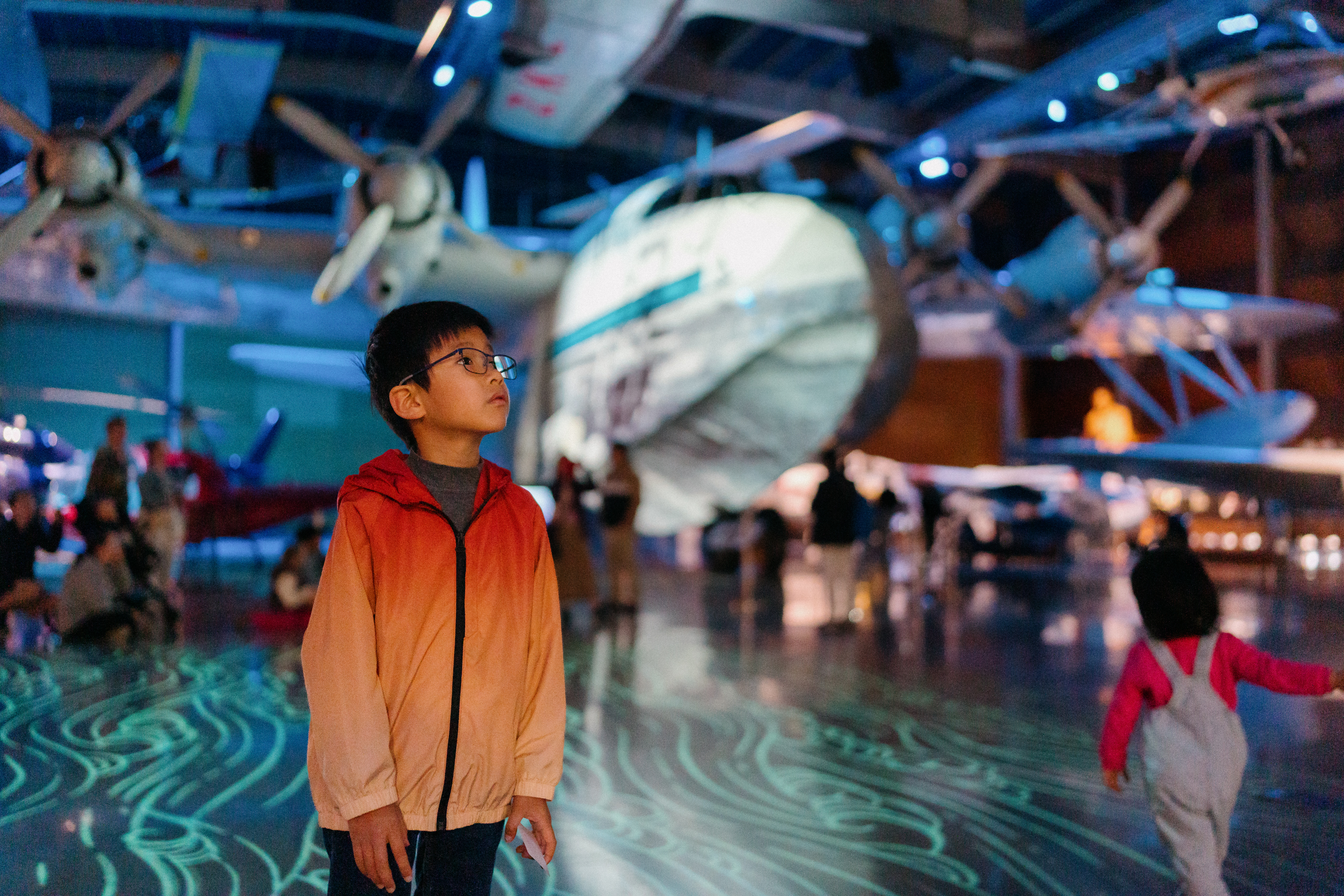 Imagery is projected onto multiple surfaces in the Aviation Hall, including the floor