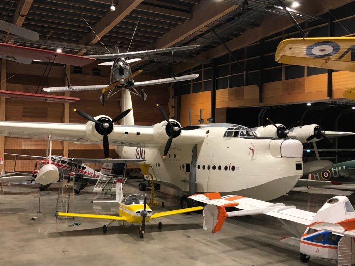 The Air Tourer 115 (Miss Jacy) below the wing of the Sunderland Flying Boat.