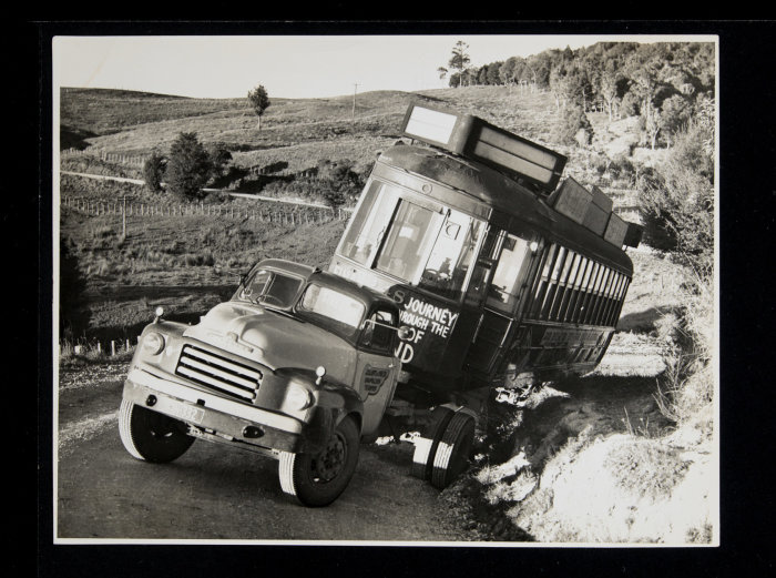 Graham Stewart. Jul 1957. [Tram 248 on back of truck stuck in ditch on its way to Matakohe, Te Tai Tokerau.] PHO-2020-19.438. Walsh Memorial Library, The Museum of Transport and Technology (MOTAT). 