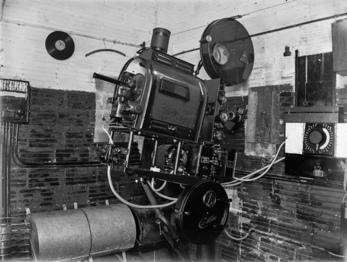 Cinema projector in projection room, 1930s. John McGuire et al. 13-2143. Walsh Memorial Library, The Museum of Transport and Technology (MOTAT).