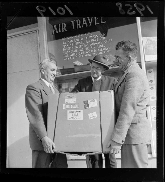 Three unidentified men holding a carton of Polio Vaccine