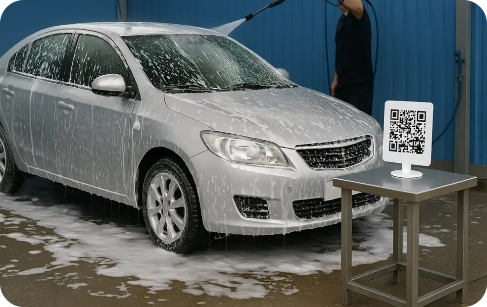 Car is washing by Shine Masters mobile car wash, their QR is on the the table nearby.