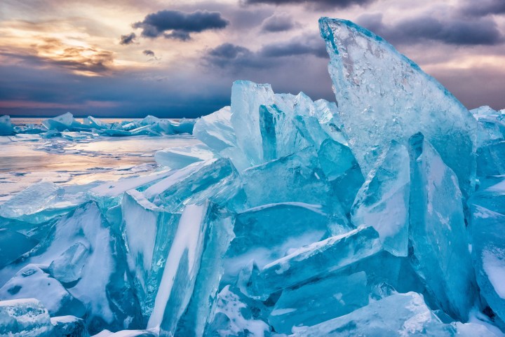 Iceberg and ice formations against a colourful sky