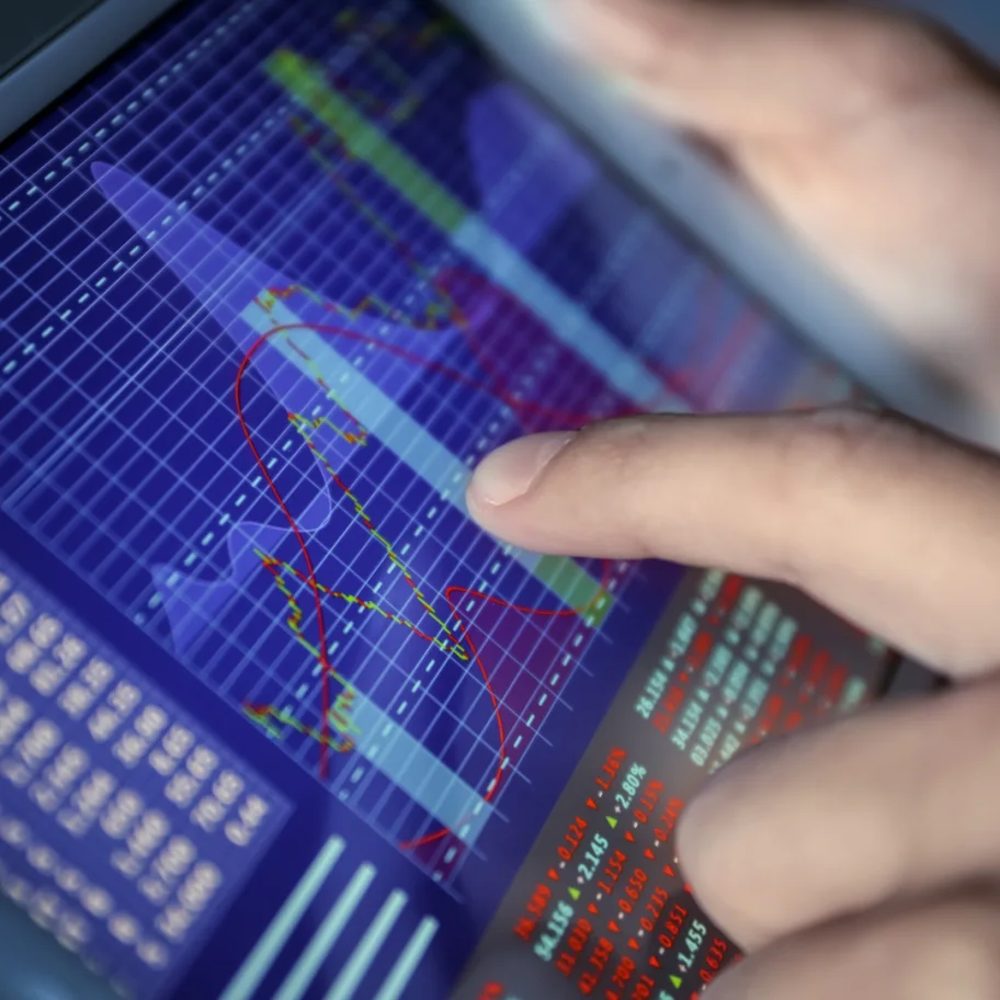 square-broker-using-tablet-computer-with-stock-data-on-screen-closeup