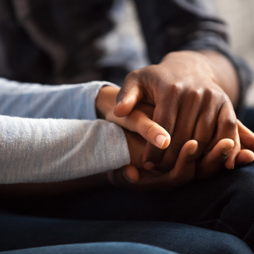 square-close-up-black-woman-and-man-in-love-sitting-on-couch-two-people-holding-hands.-symbol-sign-sincere-feelings-compassion-loved-one-say-sorry.-reliable-person-trusted-friend-true-fr