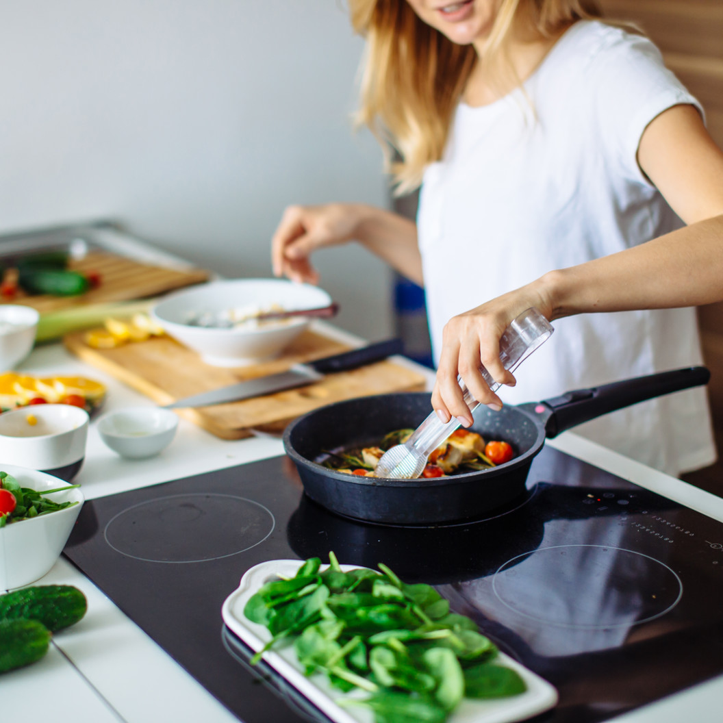 square-young-blonde-woman-cooking-in-the-kitchen.-healthy-food.-dieting-concept.-healthy-lifestyle.-cooking-at-home.-prepare-food