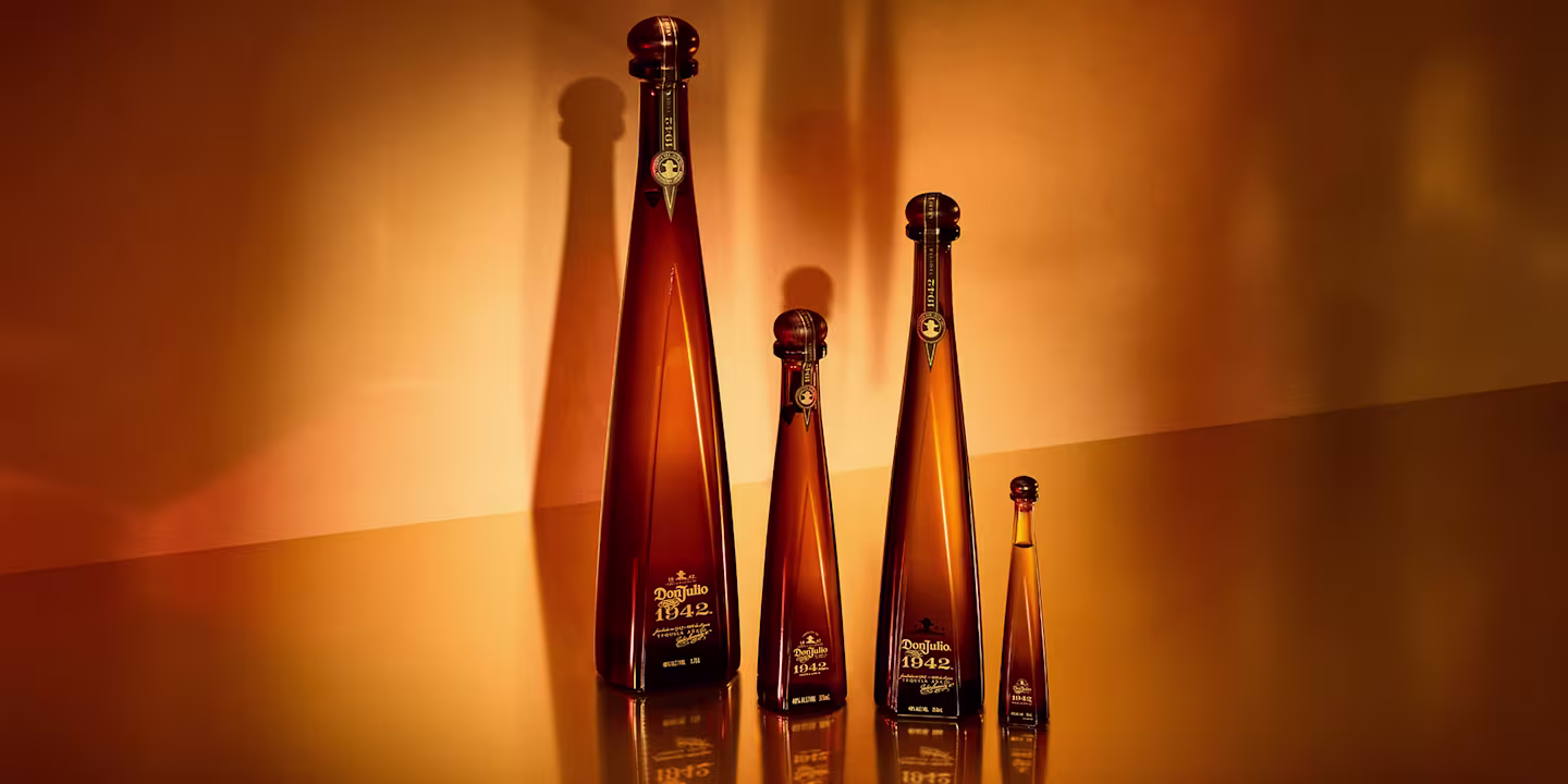 A bottle of Don Julio 1942 surrounded by gifts.