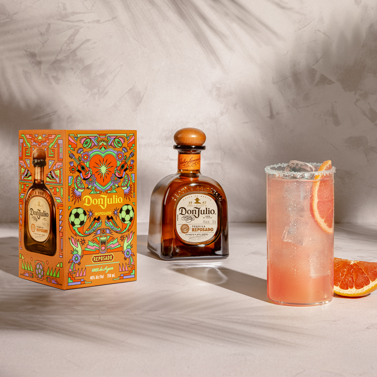 Tequila Don Julio Reposado Paloma cocktail next to a Tequila Don Reposado Summer of Mexicana box designed by Raul Urias.