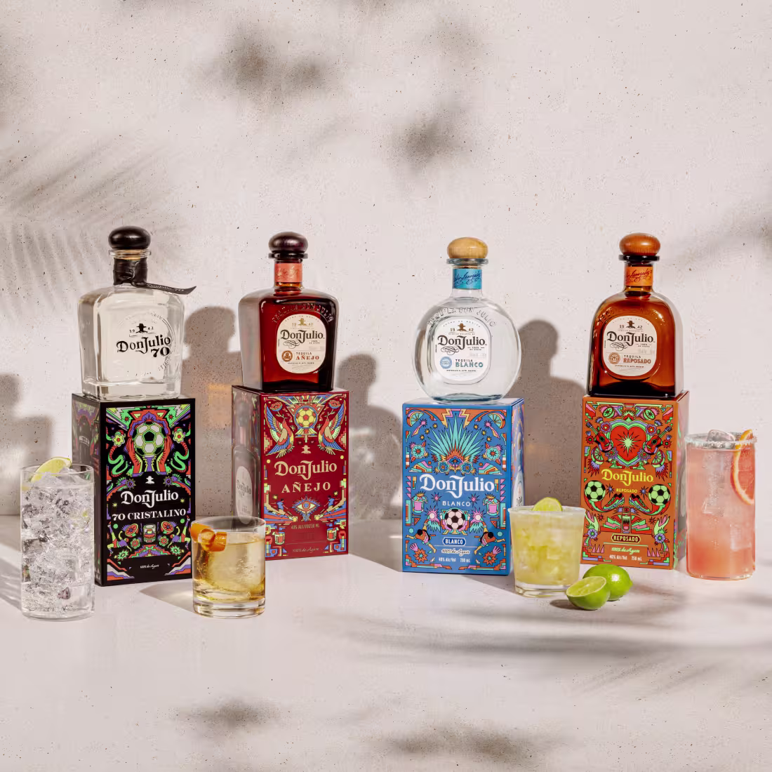 A lineup of cocktails and limited-edition Don Julio 70 Cristalino, Don Julio Blanco, Don Juilo Anejo, and Don Julio Reposado artist packs designed by Raul Urias.