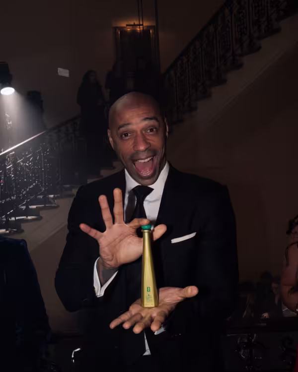 Thierry Henry holding Tequila Don Julio 1942 50ml FIFA special edition bottle.