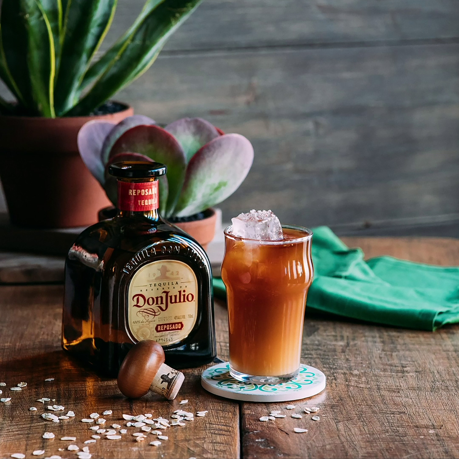 A glass of Reposado Cold Brew cocktail recipe on a table next to a bottle of Don Julio Reposado