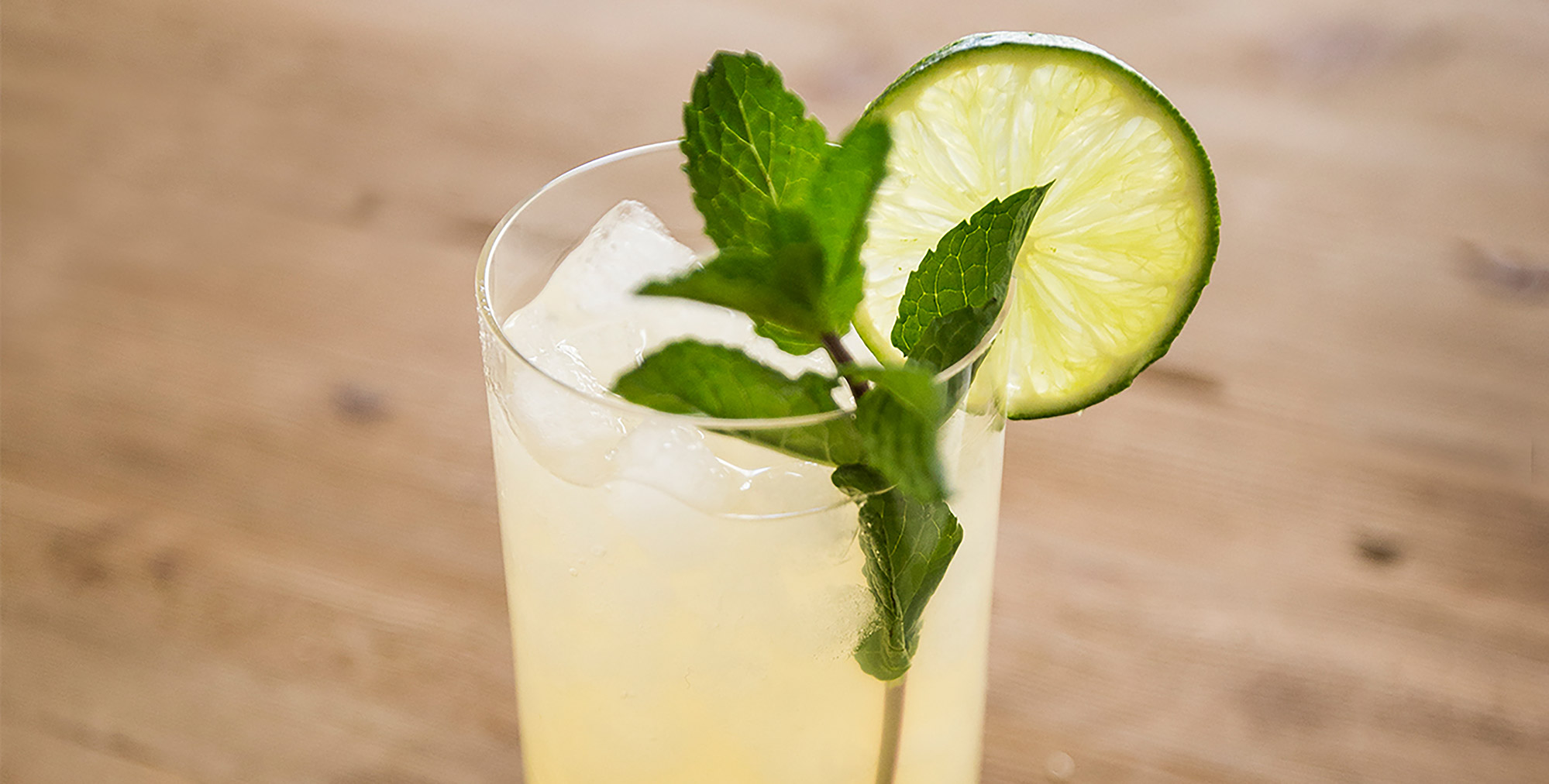 A glass of Don Julio Blanco Mojito garnished with mint and a lime wheel