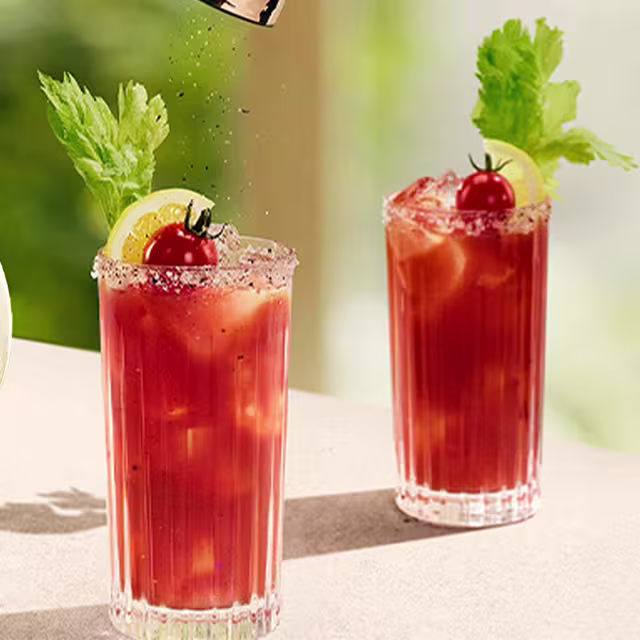 A bottle of Don Julio Reposado with a glass of Bloody Maria cocktail on each side