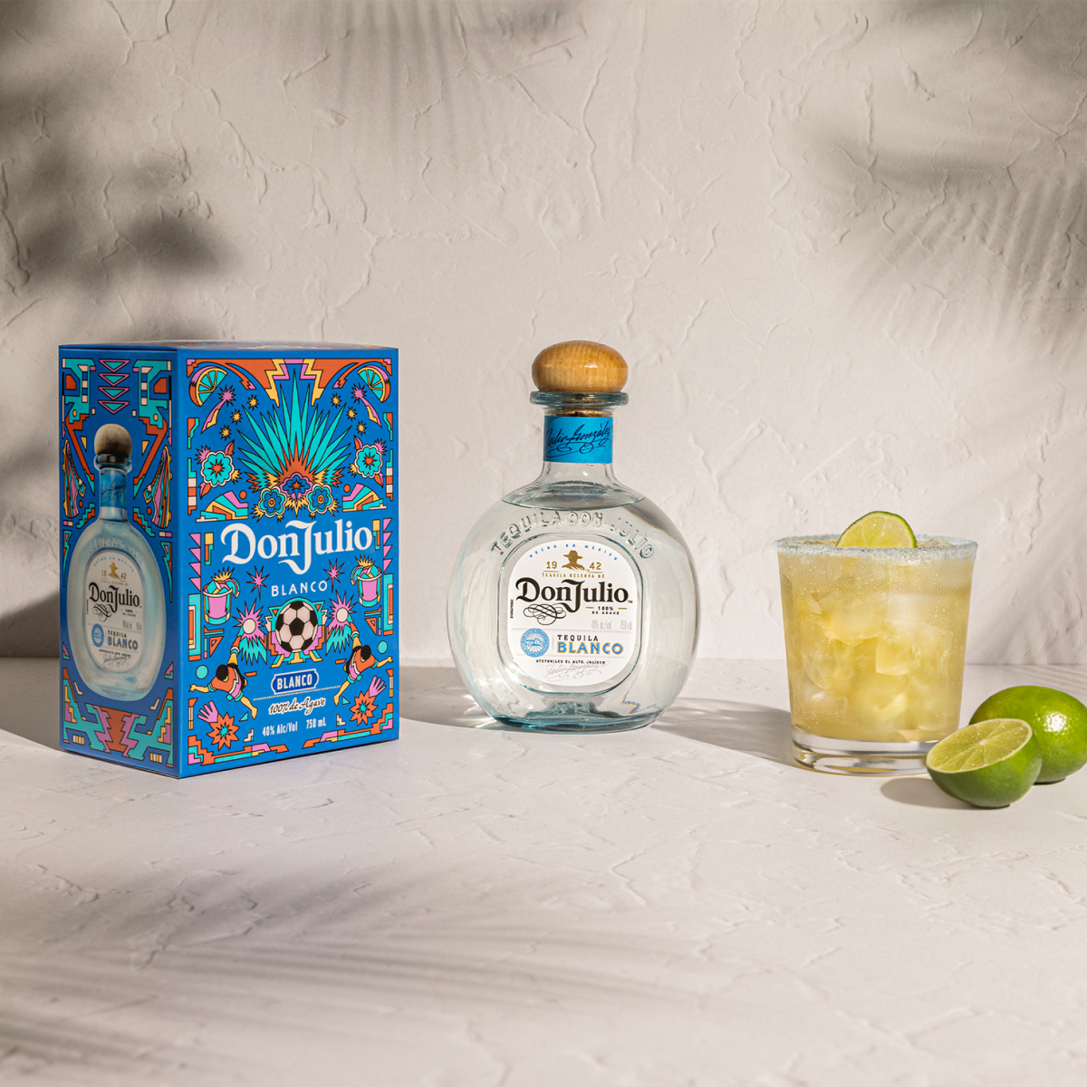 Tequila Don Julio Blanco Margarita cocktail next to a Tequila Don Julio Blanco Summer of Mexicana box designed by Raul Urias.