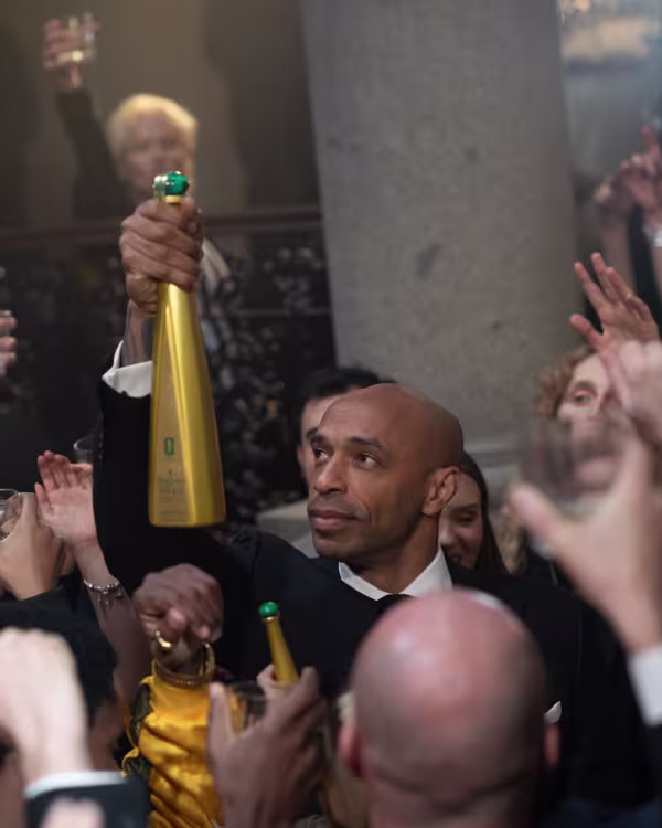 Thierry Henry raising bottle of Tequila Don Julio 1942 FIFA special edtiion bottle.