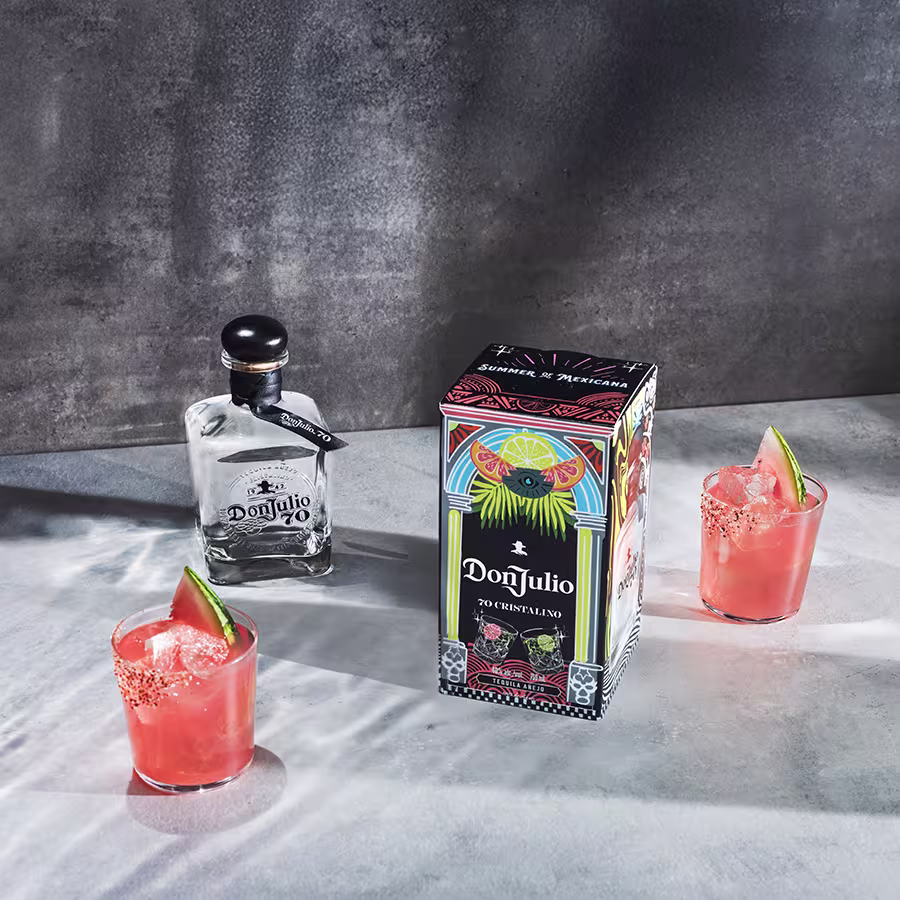 Two Tequila Don Julio Sandia Margarita cocktails next to a Tequila Don Julio 70 Cristalino Summer of Mexicana box