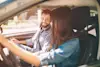 Man and woman sitting in car. 